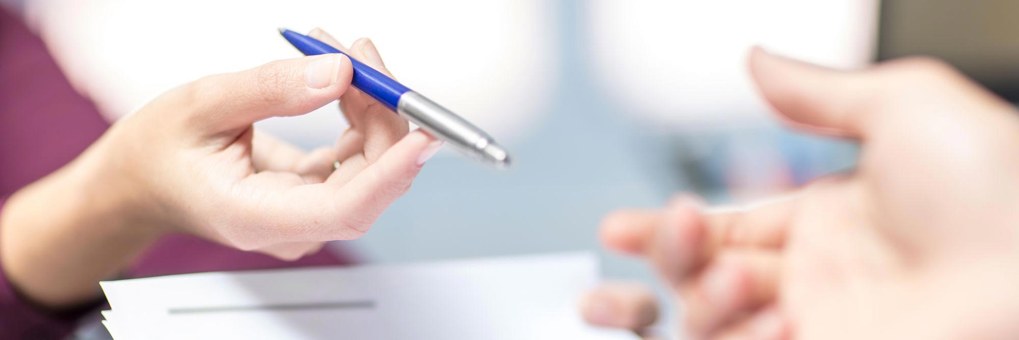 Person handing over a pen